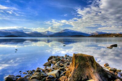 Loch Lomond: A serene and expansive Scottish loch surrounded by rolling hills and lush forests.