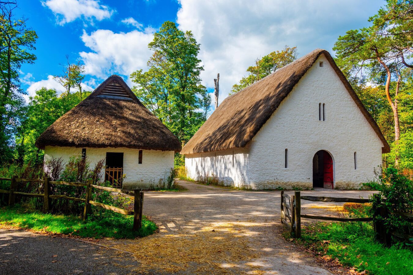 Exterior view of St. Fagans National Museum of History, a renowned open-air museum in Wales, surrounded by lush greenery and historic buildings.